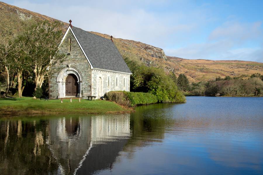 A small stone chapel beside a still lake